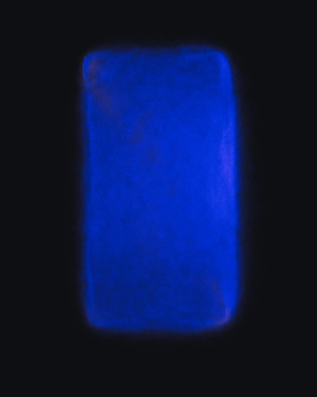 A soft, luminous rectangle fading into darkness